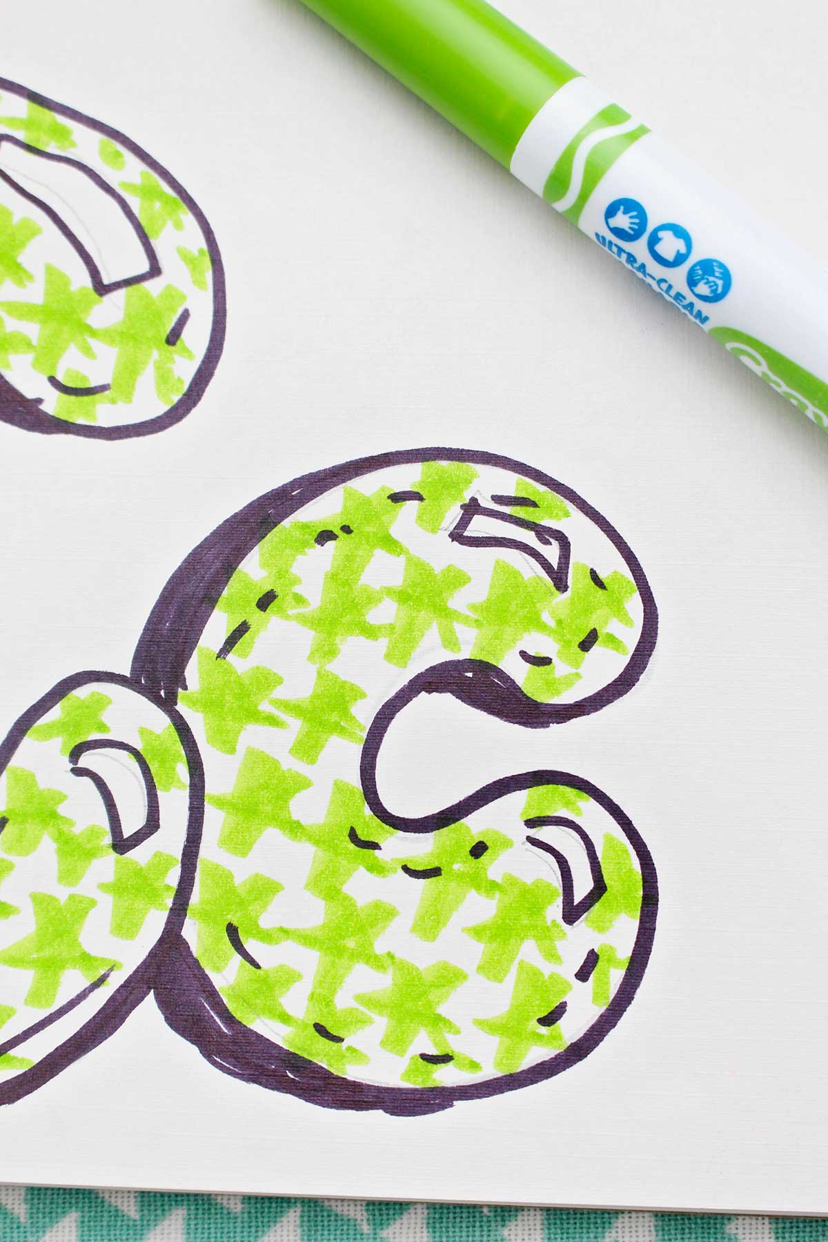 A close up of a completed bubble letter lowercase "c".