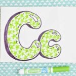 Bubble letter "C" in upper and lowercase shadowed in sharpie and colored in with light green marker star pattern.