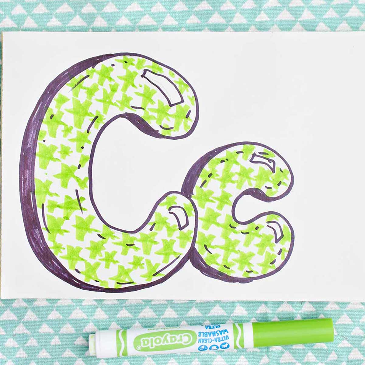 Bubble letter "C" in upper and lowercase shadowed in sharpie and colored in with light green marker star pattern.