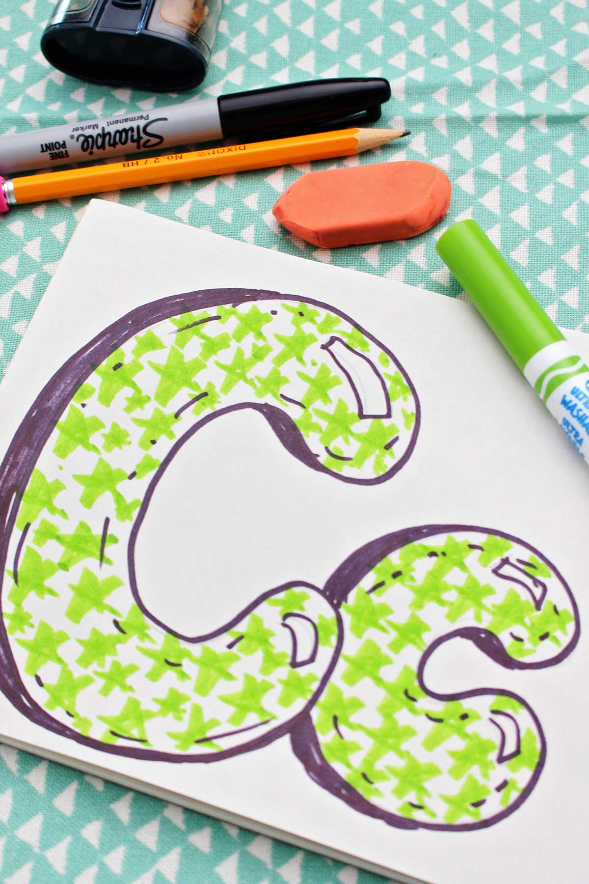 Close up of completed upper and lowercase "c"s.