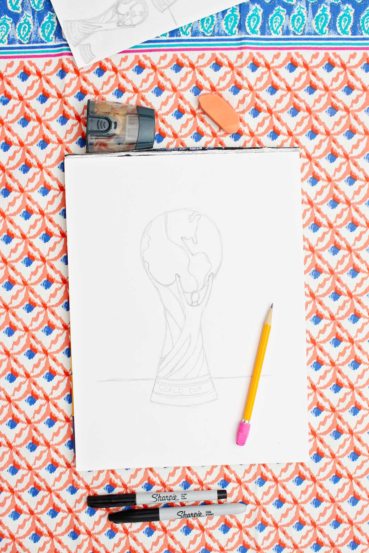 A pencil sketch of the FIFA World Cup trophy.