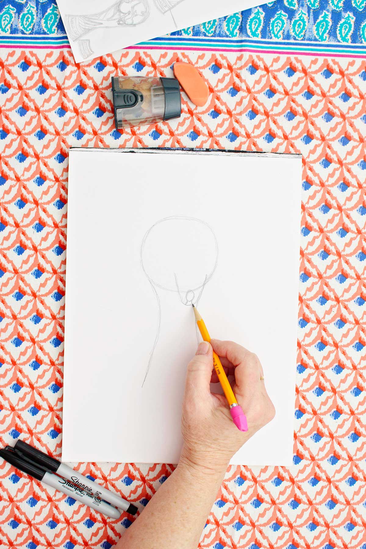 A person sketching a person on their FIFA World Cup Trophy.