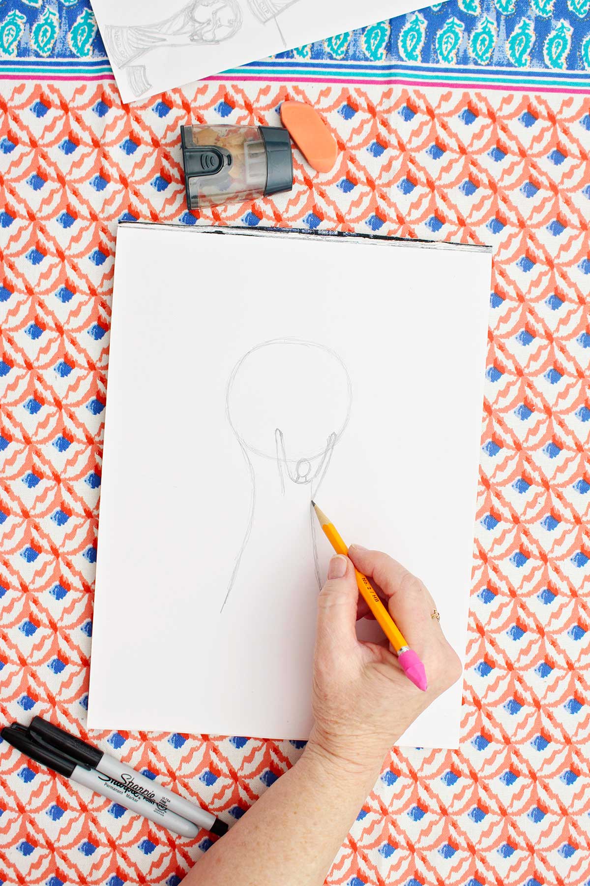 A person sketching a person on their FIFA World Cup Trophy.