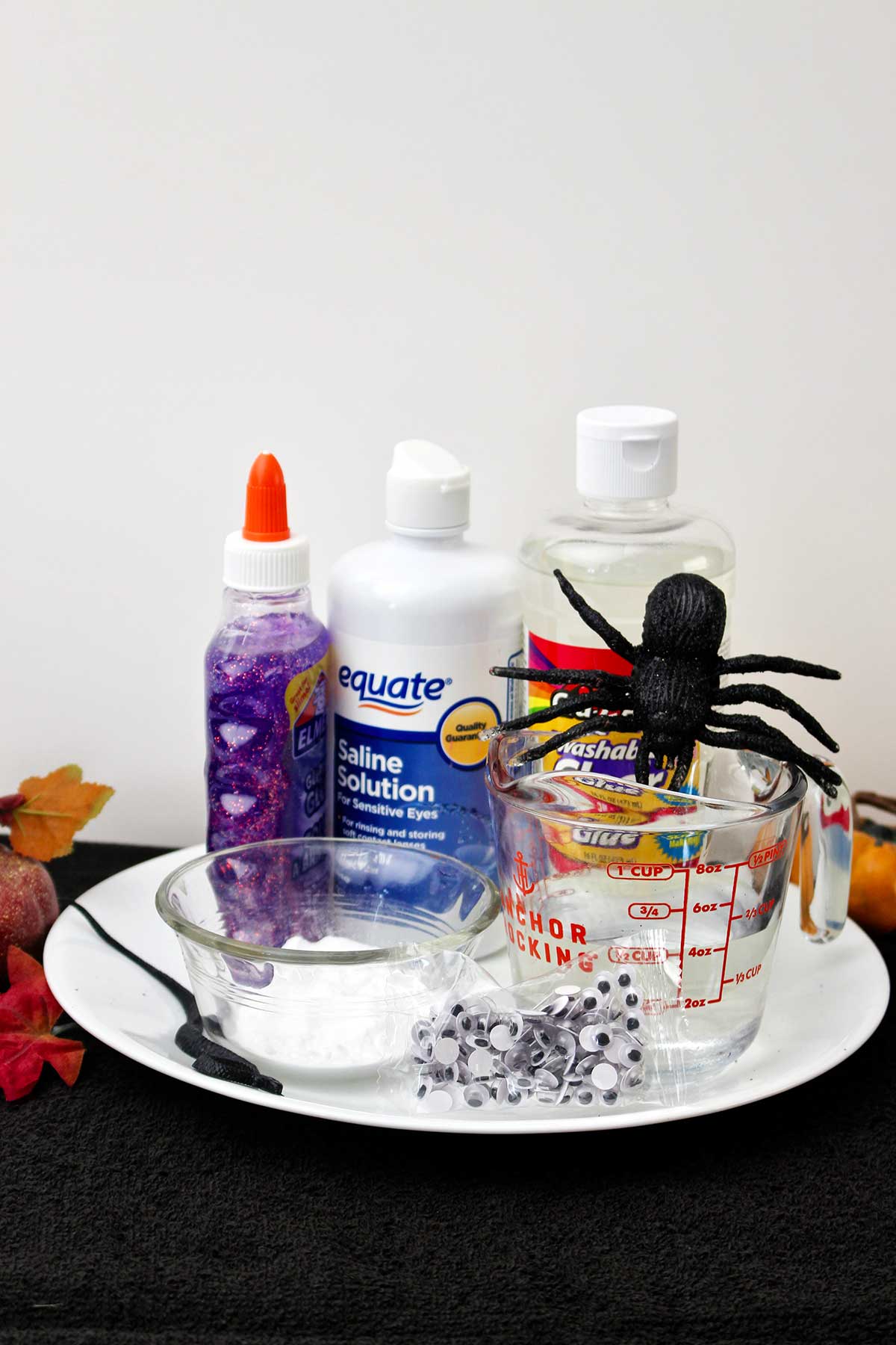 Saline solution, glitter glue, clear glue and googly eyes.