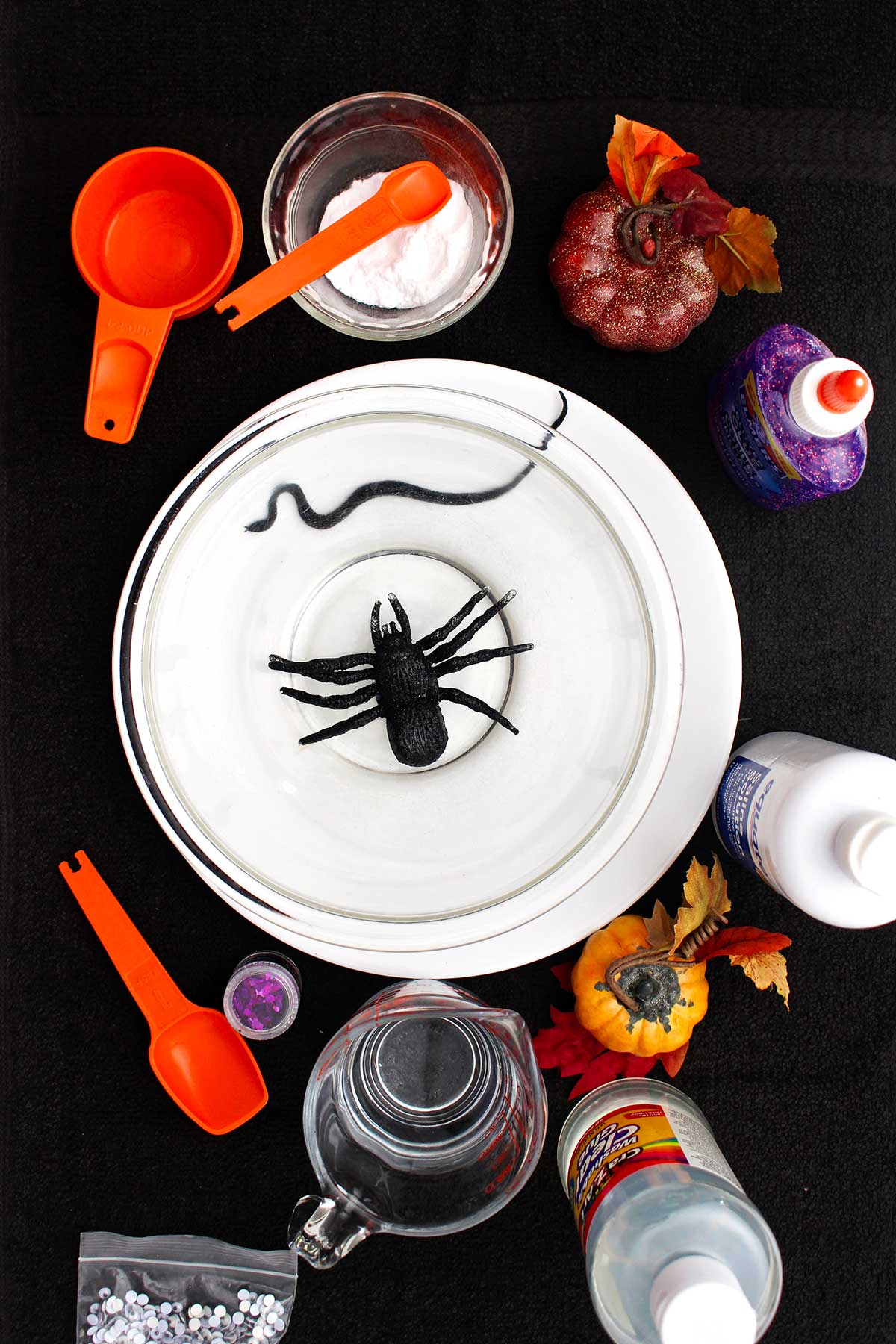 Overhead view of all the components of a halloween slime including spooky spider.