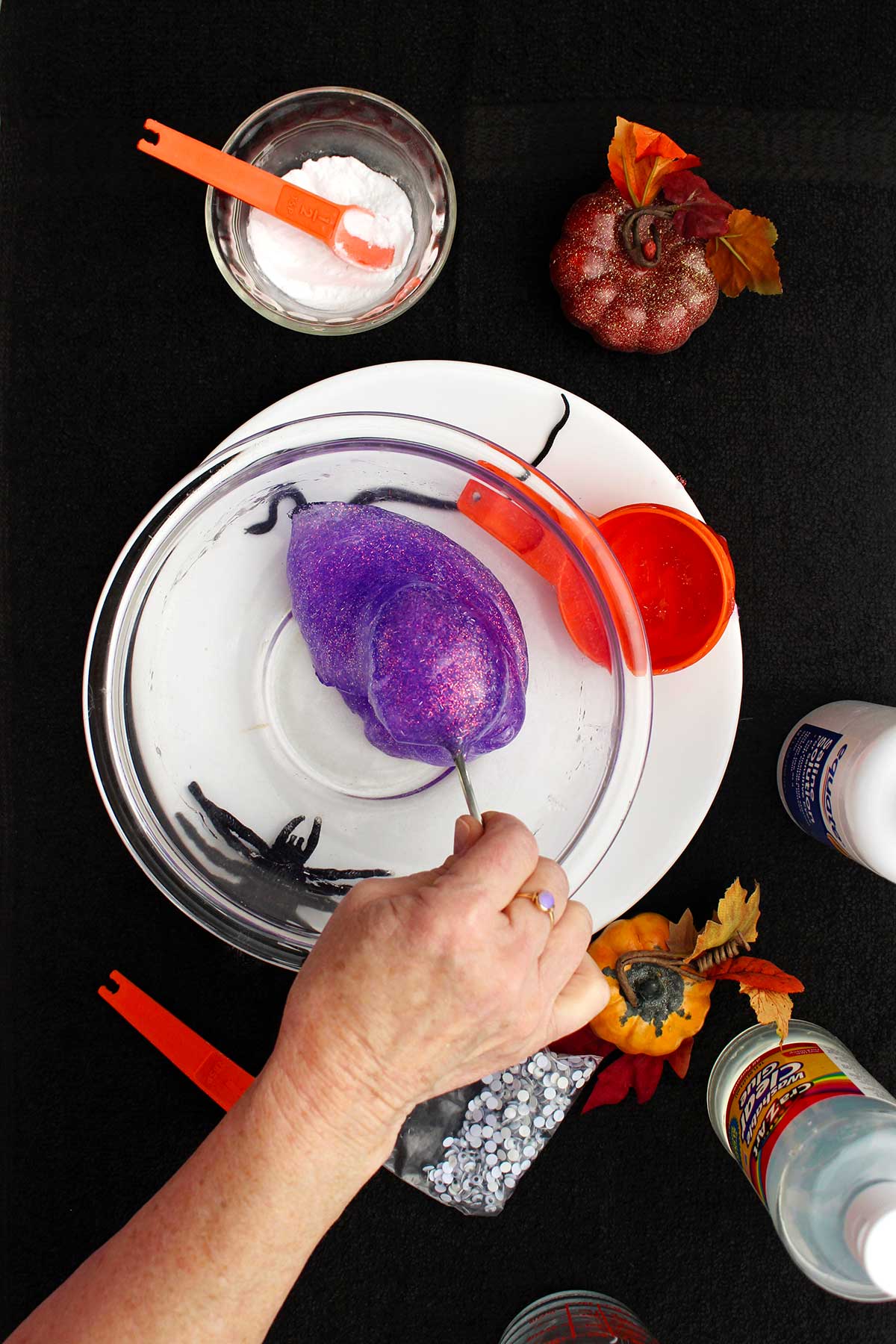 Person stirring a more firm and almost complete sparkly slime.
